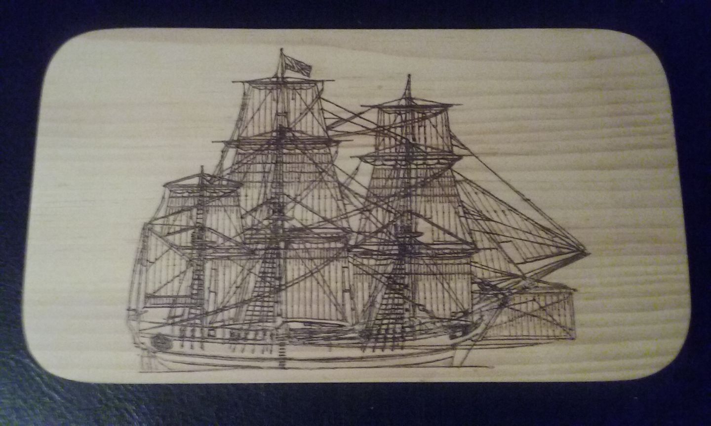 Detailed hand burned tall sailing ship on wood