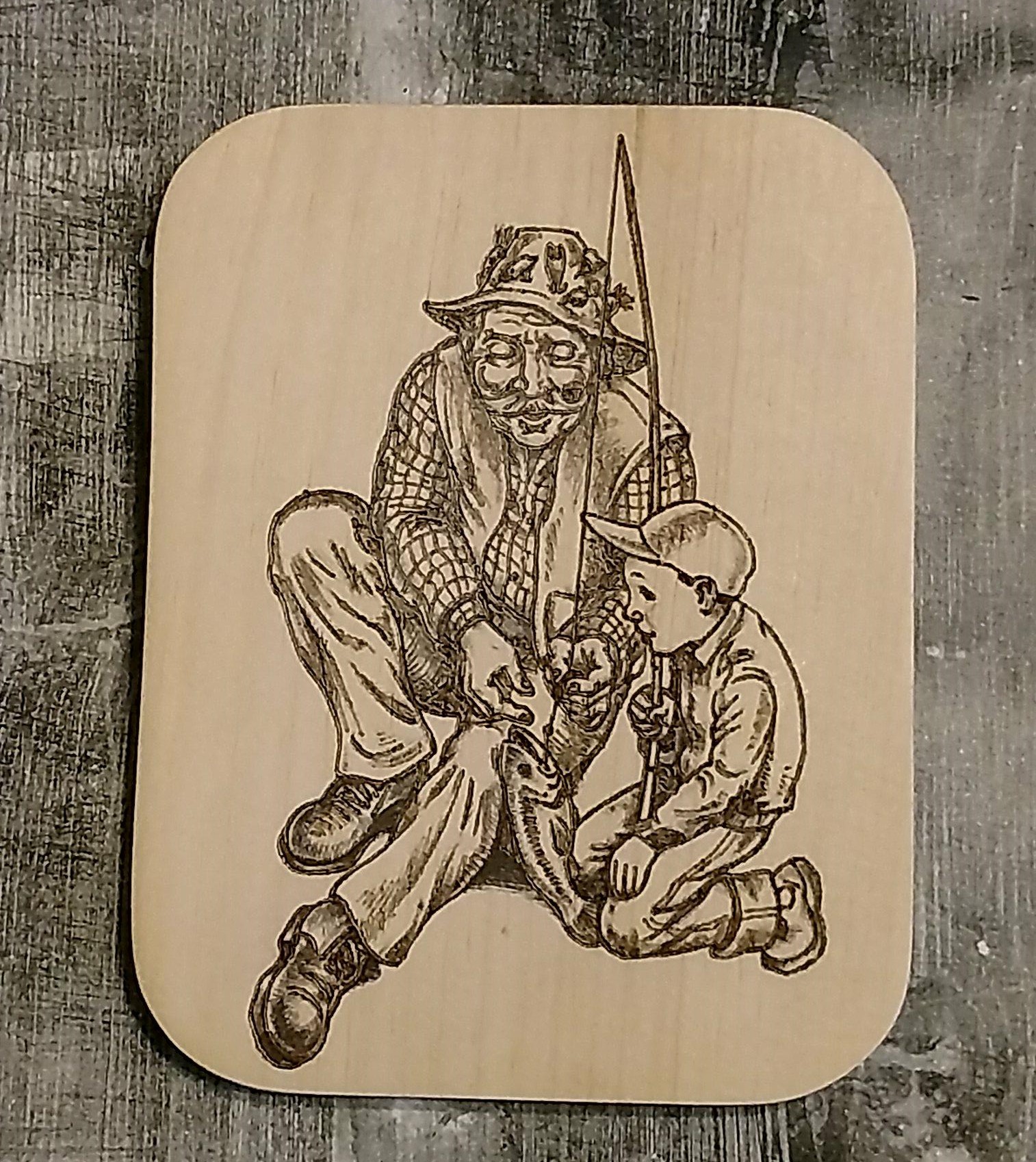 Hand burned scene of a grandfather fishing with a child