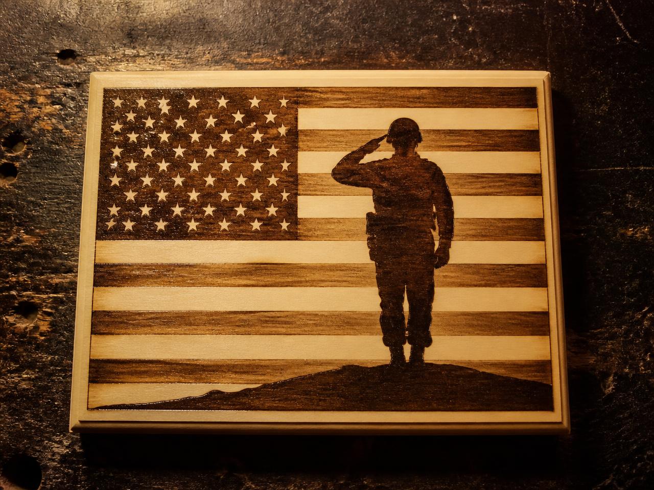 Hand burned American flag plaque with a saluting soldier